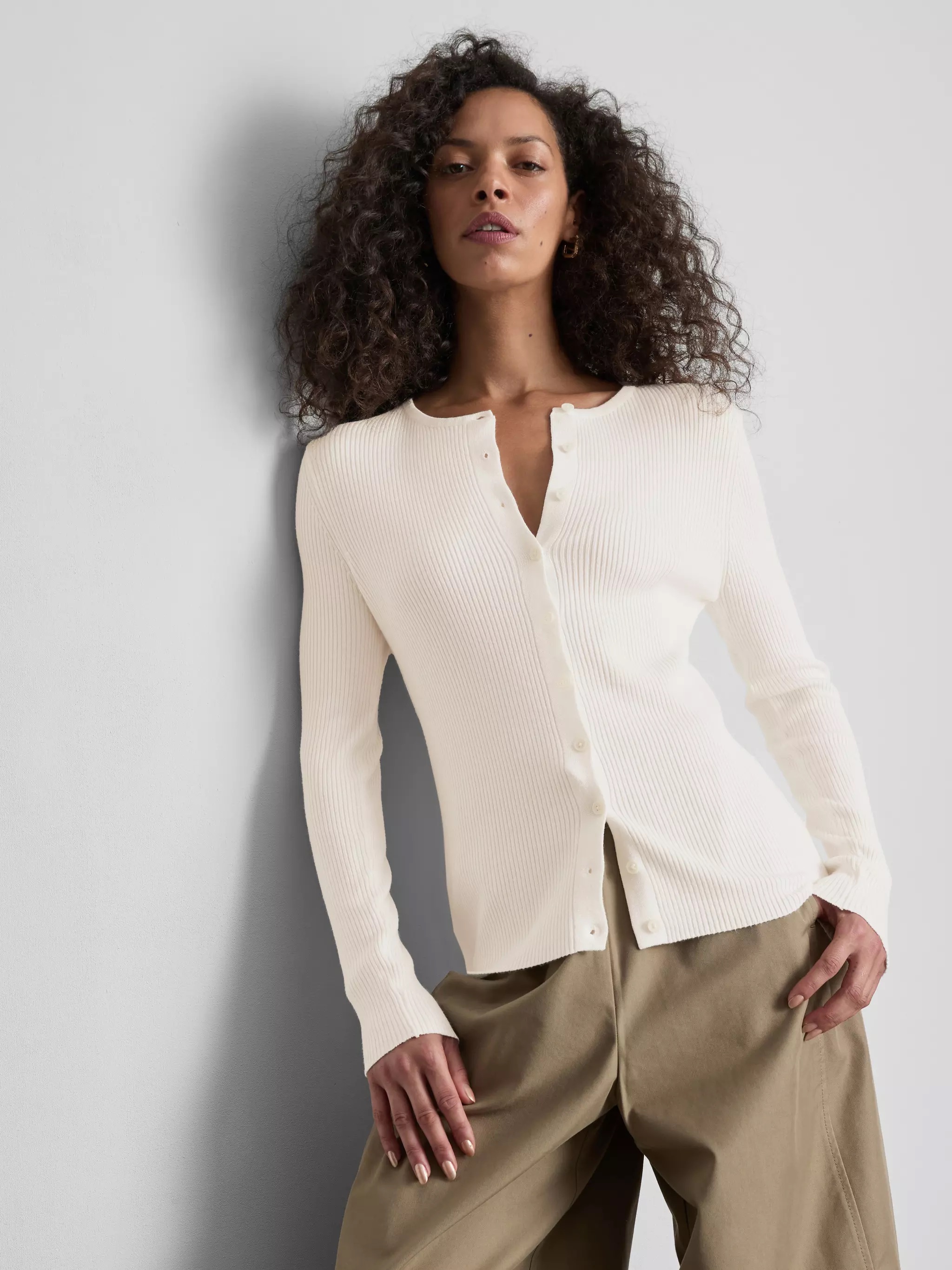 Woman wearing a white cardigan.