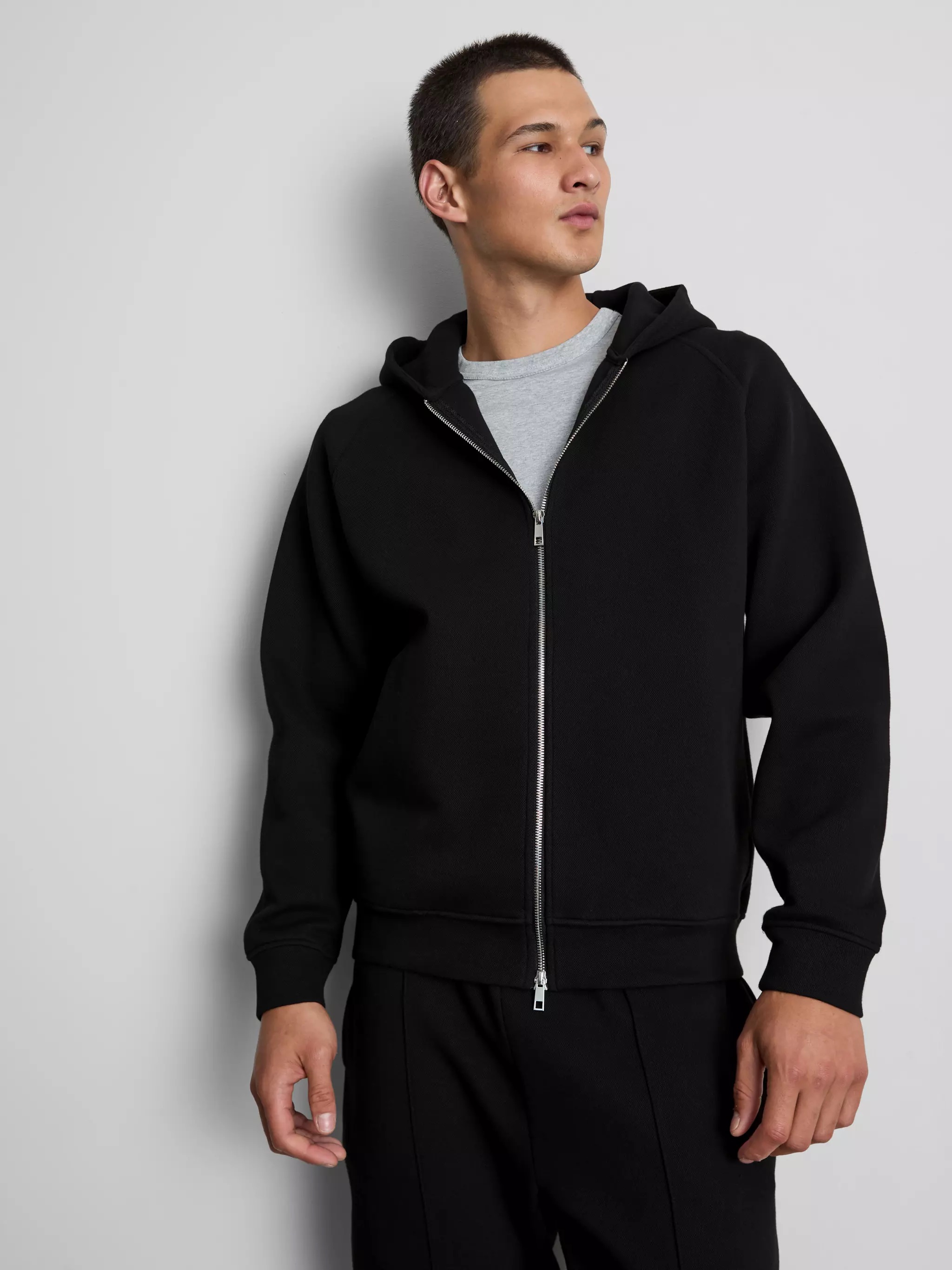 Man wearing a black hoodie.