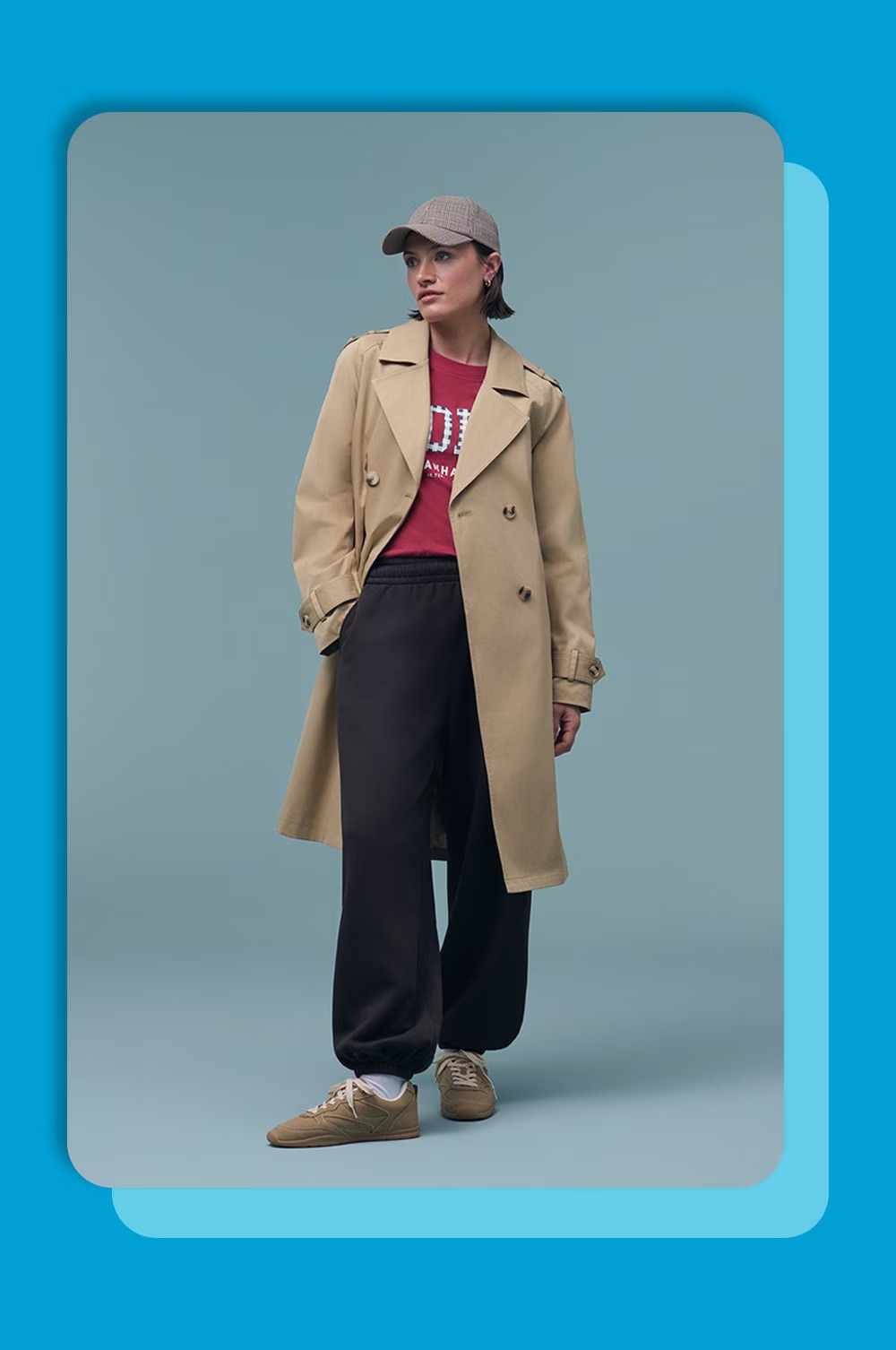 Woman wearing trench and joggers.